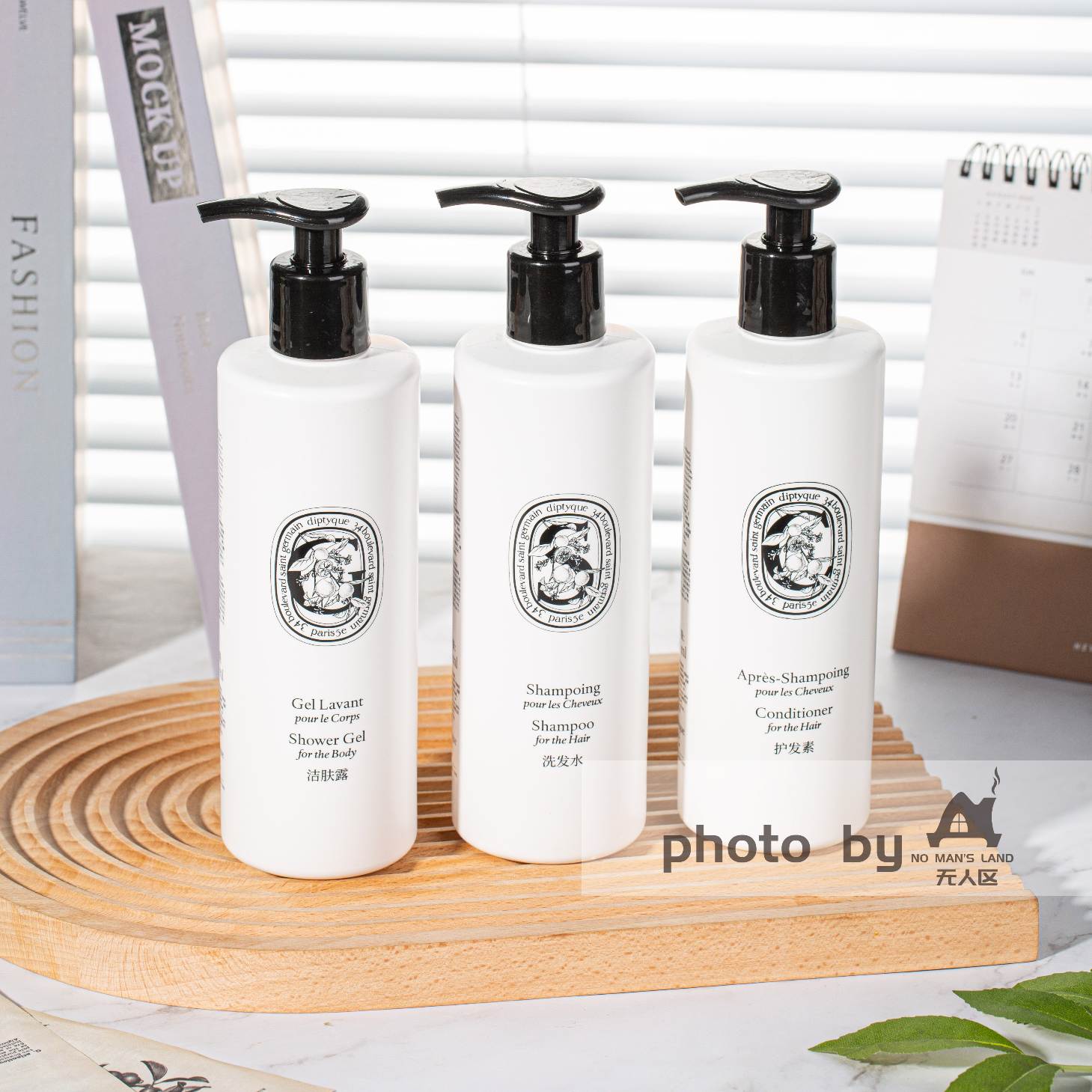 DIPTYQUE shampoo and conditioner and body lotion on table