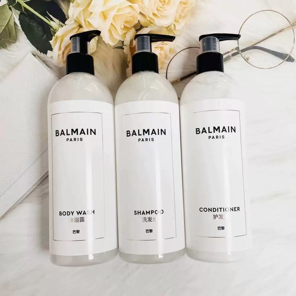 three bottles of Balmain hotel toiletries showed