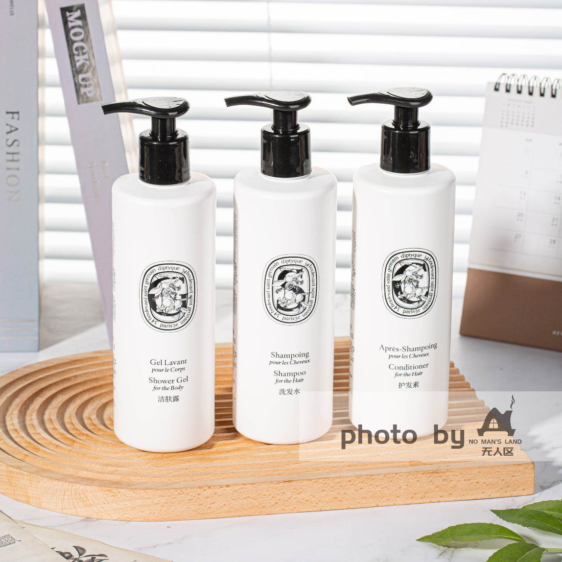 DIPTYQUE shampoo and conditioner and body lotion on table