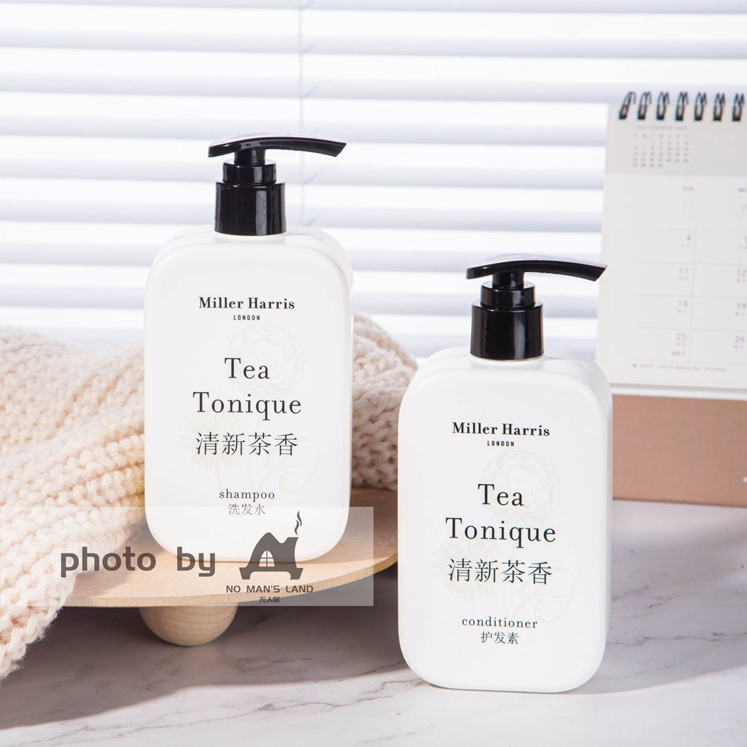 2 bottles of Miller Harris shampoo and conditioner displayed on the tray.